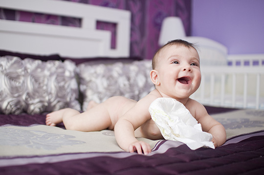 Two-year old boy with pants down wearing diapers, Stock Photo